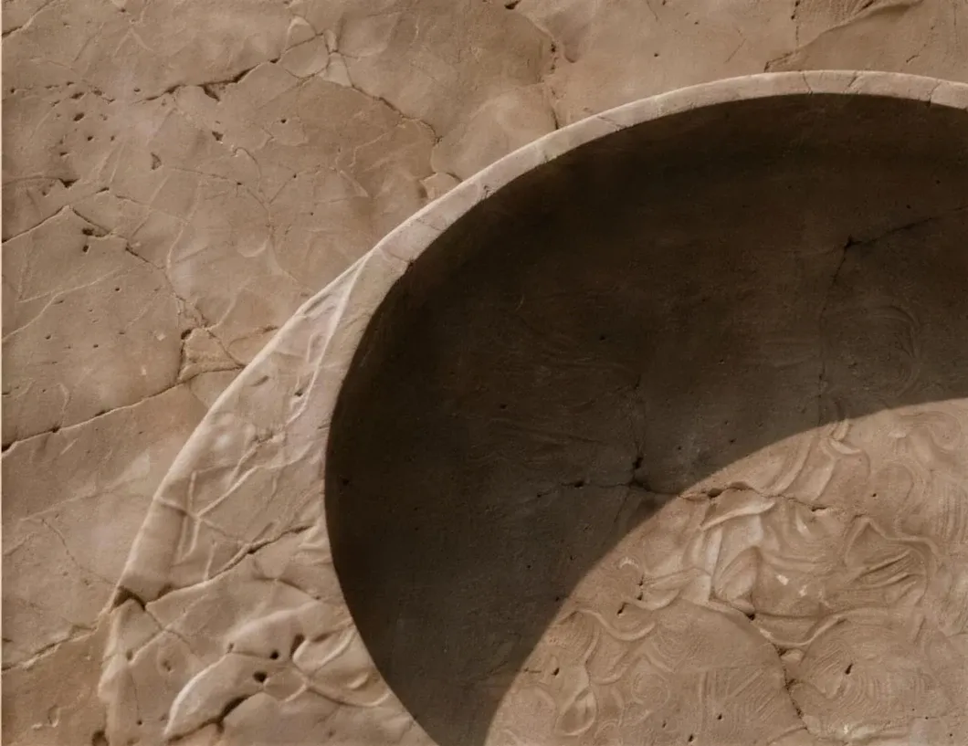 A carved stone form catching soft directional light